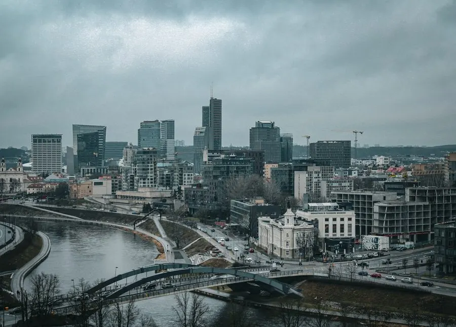 Vilnius business district and the Neris under a heavy grey sky.